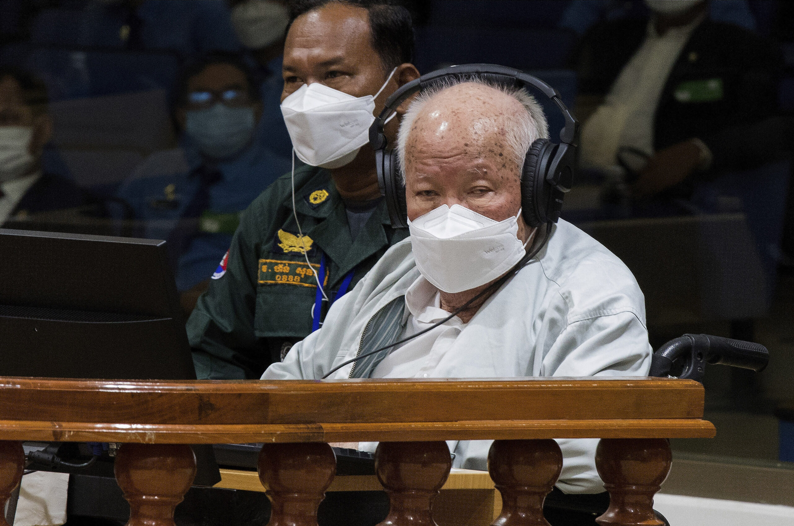In this photo released by the Extraordinary Chambers in the Courts of Cambodia, Khieu Samphan, right, the former head of state for the Khmer Rouge, sits in a courtroom during a hearing at the U.N.-backed war crimes tribunal in Phnom Penh, Cambodia, Thursday, Sept. 22, 2022. The international court convened in Cambodia to judge the brutalities of the Khmer Rouge regime that caused the deaths of an estimated 1.7 million people in the 1970s ends its work Thursday after spending $337 million and 16 years to convict just three men of crimes. (Nhet Sok Heng/Extraordinary Chambers in the Courts of Cambodia via AP)