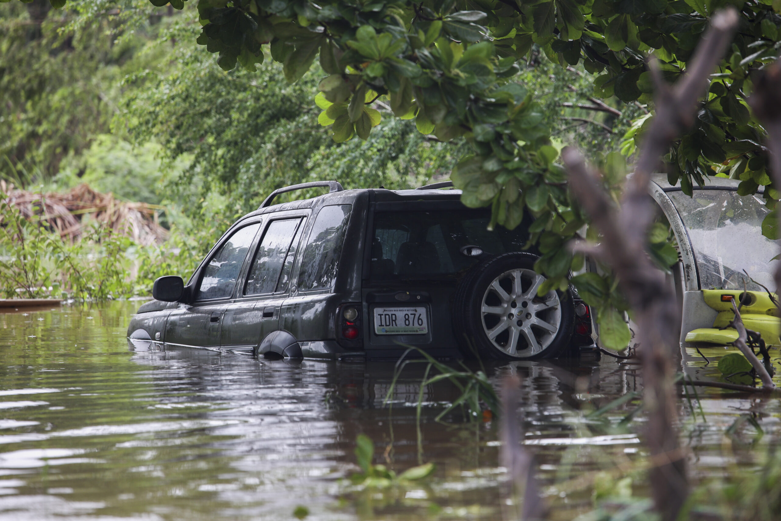 A vehicle is submerged after Hurricane Fiona in Salinas, Puerto Rico, Monday, Sept. 19, 2022. (AP Photo/Stephanie Rojas)