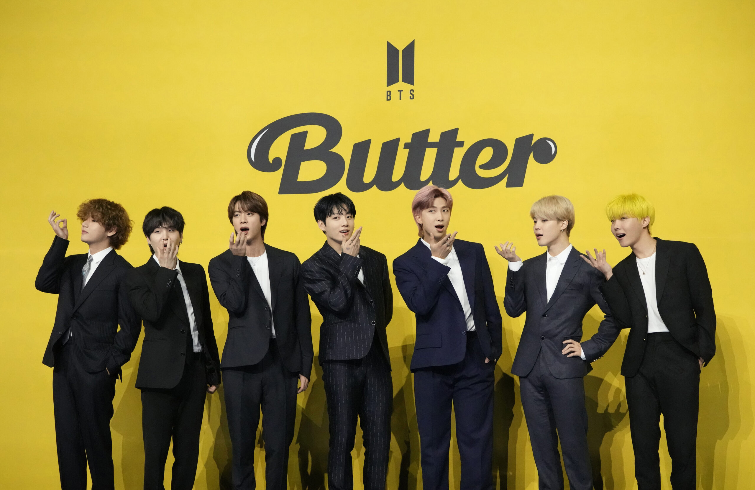 FILE- Members of South Korean K-pop band BTS, V, SUGA, JIN, Jung Kook, RM, Jimin, and j-hope from left to right, pose for photographers ahead of a press conference to introduce their new single "Butter" in Seoul, South Korea, Friday, May 21, 2021. South Korea may conduct a public survey to help determine whether to grant exemptions of the mandatory military service to members of the K-pop superstar boyband BTS, officials said Wednesday, Aug. 31, 2022.(AP Photo/Lee Jin-man, File)