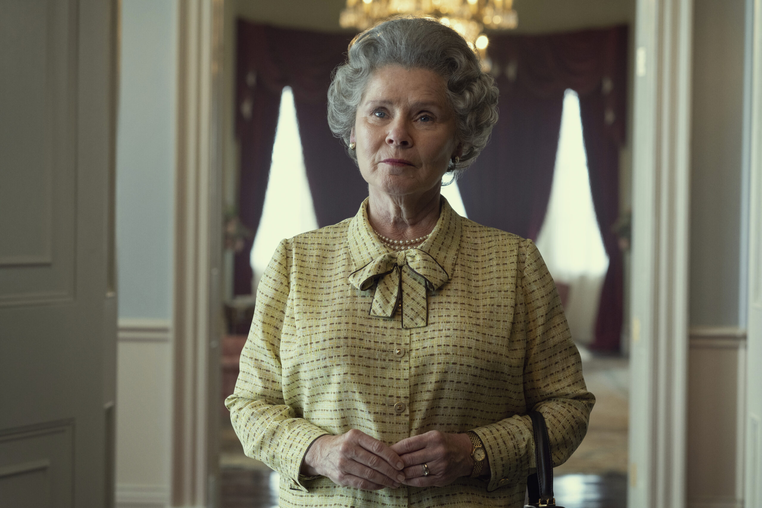 This image released by Netflix shows Imelda Staunton as Queen Elizabeth in "The Crown." Netflix’s acclaimed series about Queen Elizabeth II and her family, has paused production due to the monarch’s death. (Alex Bailey/Netflix via AP)