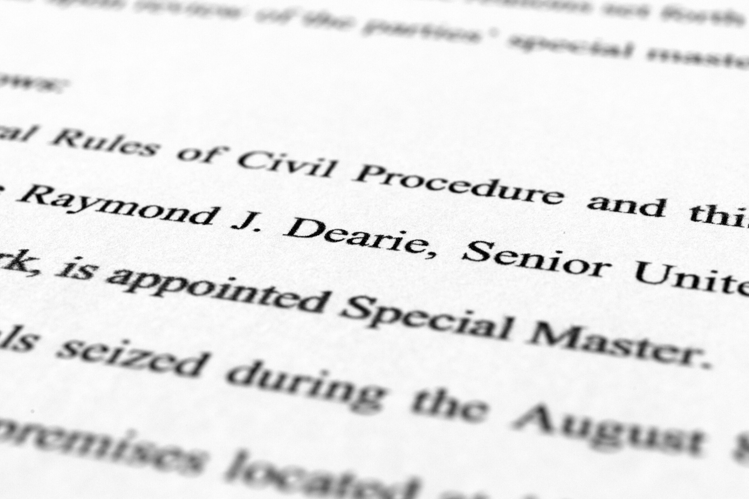 A page from the order by U.S. District Judge Aileen Cannon naming Raymond Dearie as special master to serve as an independent arbiter and to review records seized during the FBI search of former President Donald Trump's Mar-a-Lago estate, is photographed Thursday, Sept. 15, 2022. (AP Photo/Jon Elswick)