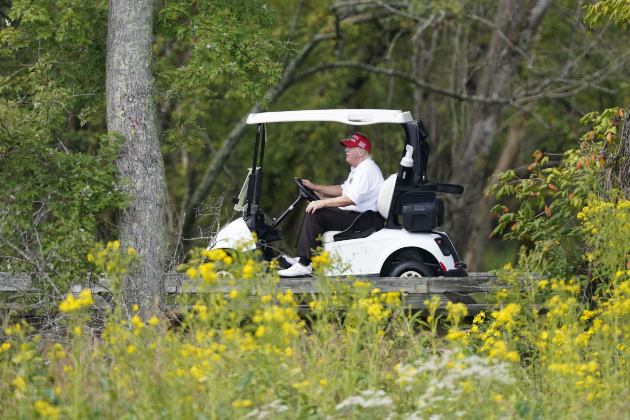 Former President Donald Trump rides around his golf course at Trump National Golf Club in Sterling, Va., Monday, Sept. 12, 2022. (AP Photo/Alex Brandon)