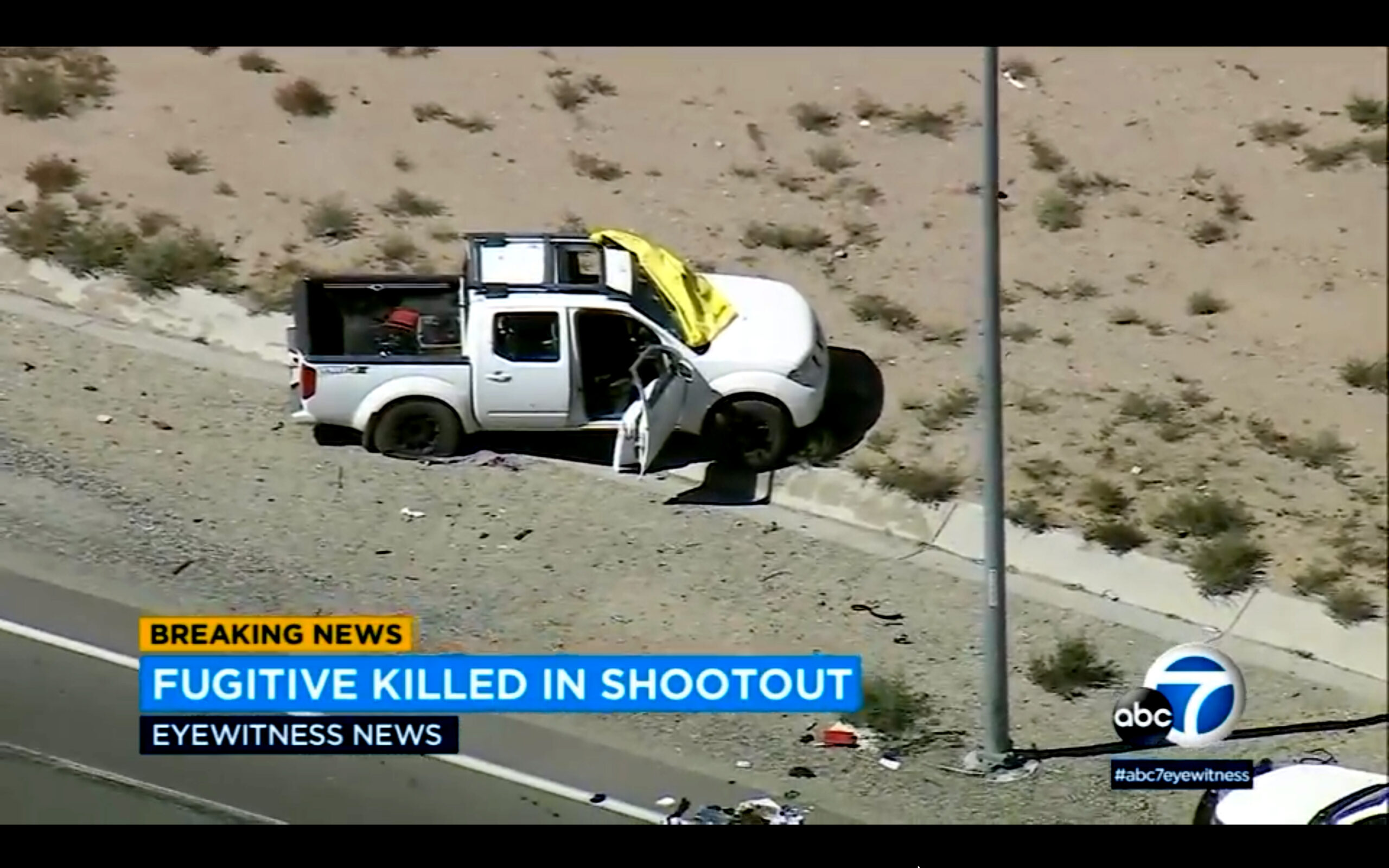 This image from video provided by KABC-TV shows a truck owned by Anthony John Graziano after a shootout on a highway in Hesperia, Calif., on Tuesday, Sept. 27, 2022. The Southern California man who was accused of killing his estranged wife and abducting their 15-year-old daughter had been living with the teenager out of his pickup truck and hotels for weeks before the violence, authorities said Wednesday, Sept. 28, 2022. (KABC-TV via AP)
