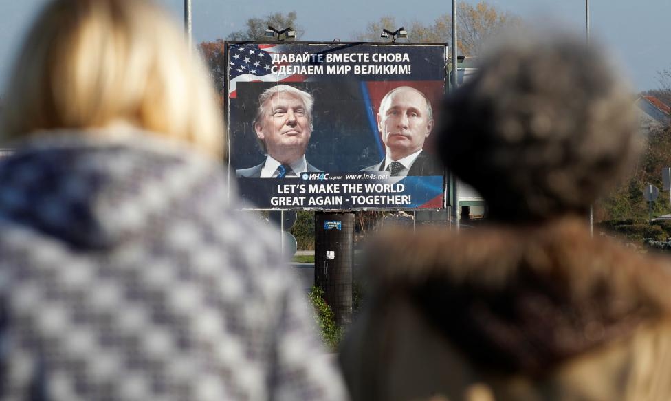 A billboard showing a pictures of President-elect Donald Trump and Russian President Vladimir Putin is seen through pedestrians in Danilovgrad, Montenegro. REUTERS/Stevo Vasiljevic